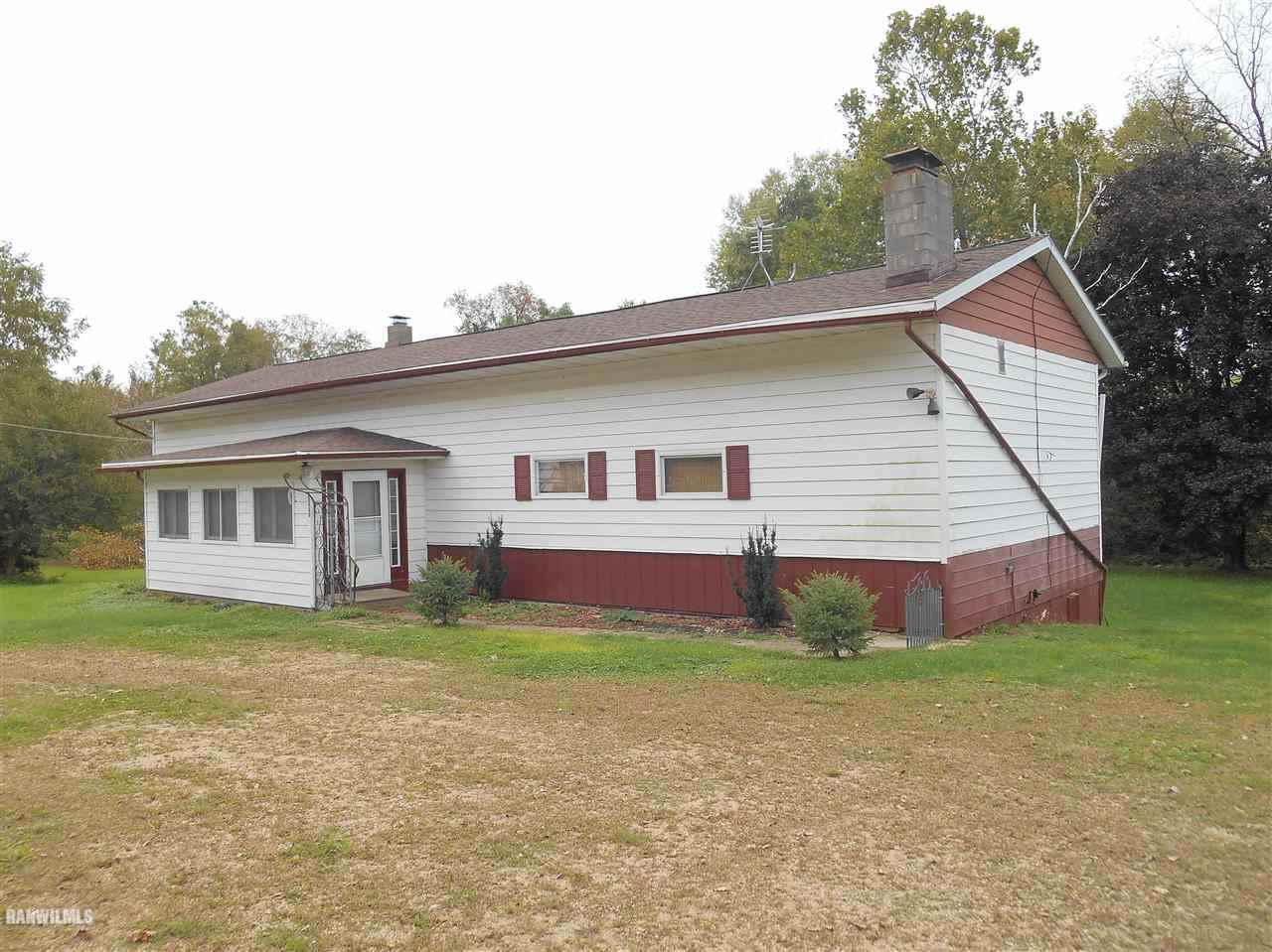 a view of a house with a yard and sitting area