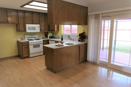 412 Veada Avenue Ridgecrest, CA 93555 - Photo 8 of 35 a kitchen with a stove a refrigerator and a sink
