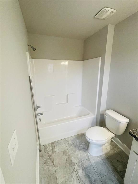 2325 Haliard Way Lithonia, GA 30058 - Photo 15 of 36 a white toilet sitting next to a bath tub and a shower