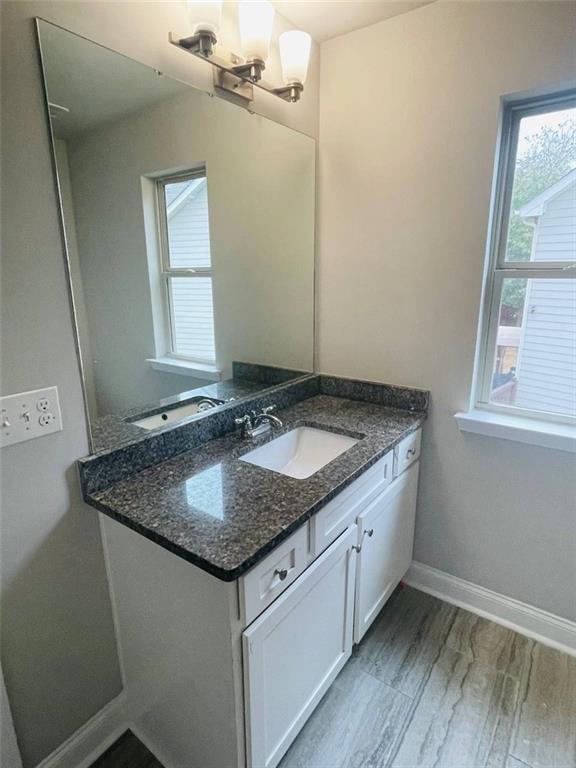 2325 Haliard Way Lithonia, GA 30058 - Photo 17 of 36 a bathroom with a granite countertop sink and a mirror