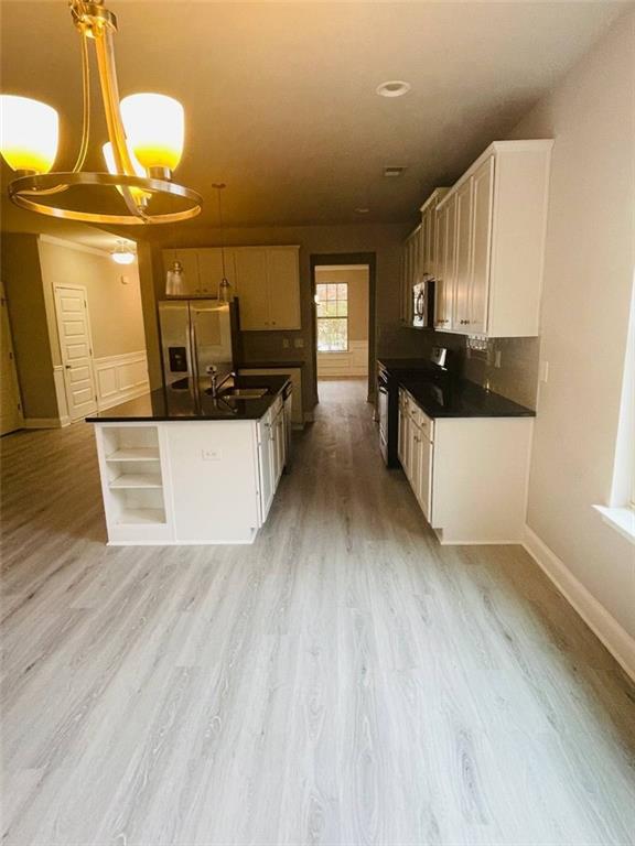 2325 Haliard Way Lithonia, GA 30058 - Photo 8 of 36 a kitchen with stainless steel appliances a stove a sink and a refrigerator