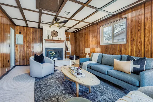 a living room with furniture a fireplace and a window