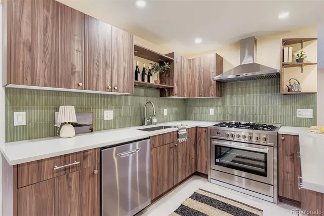 a kitchen with stainless steel appliances a stove a sink and a cabinets
