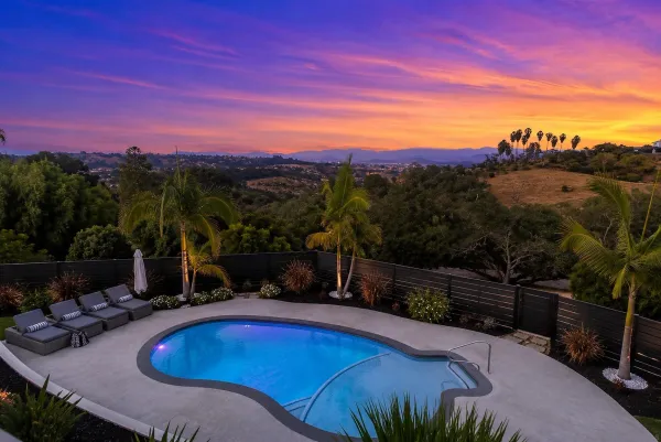 a view of a swimming pool with an outdoor space and seating area