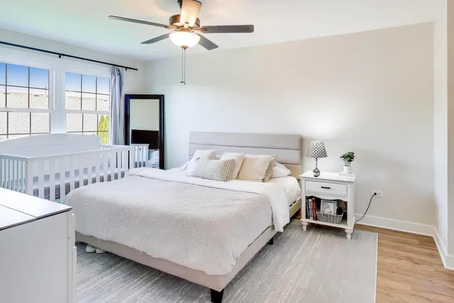 a bedroom with bed and a large window