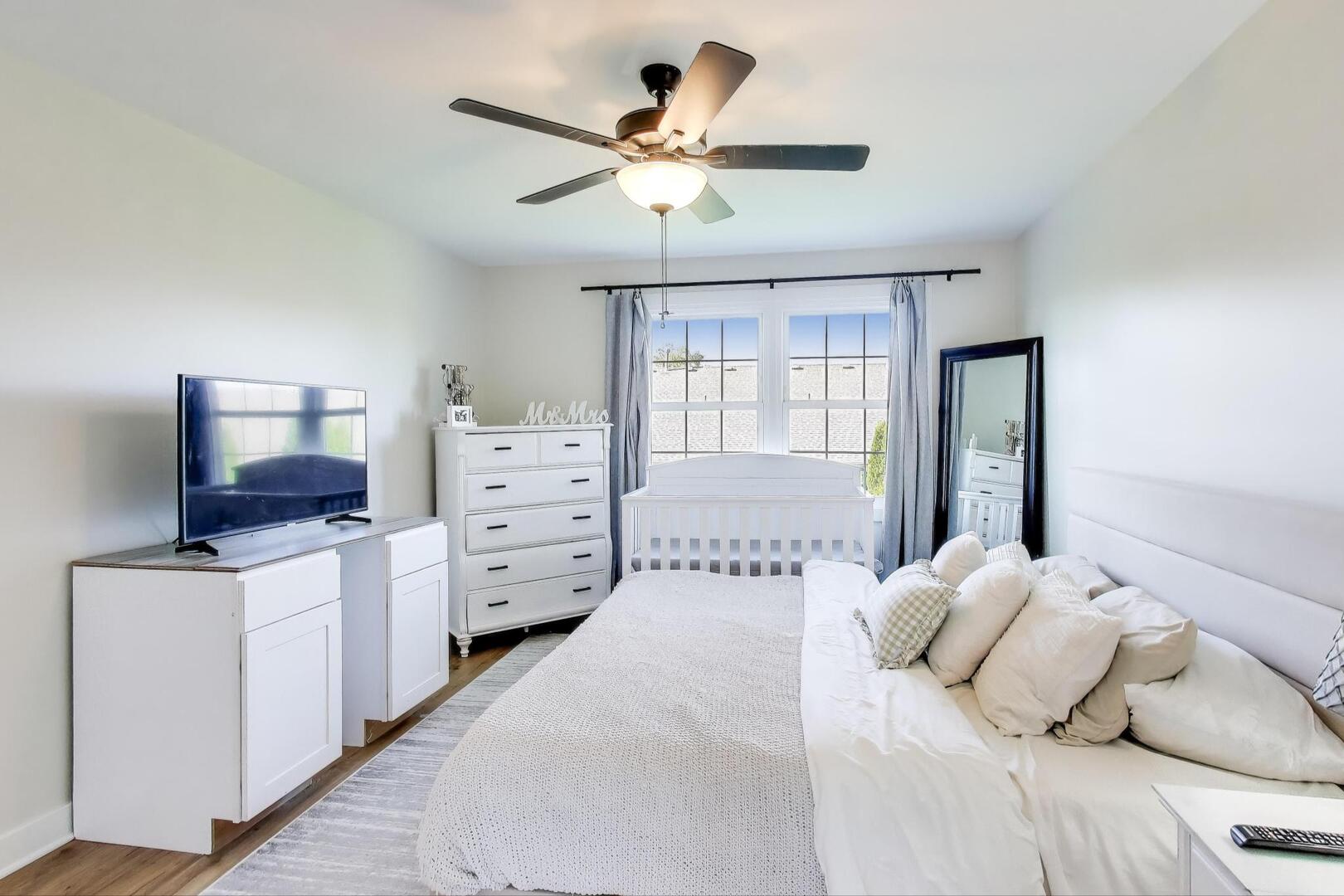 10521 Thornham Lane, Unit 10521 Mokena, IL 60448 - Photo 12 of 21 a bedroom with a large bed and a chandelier