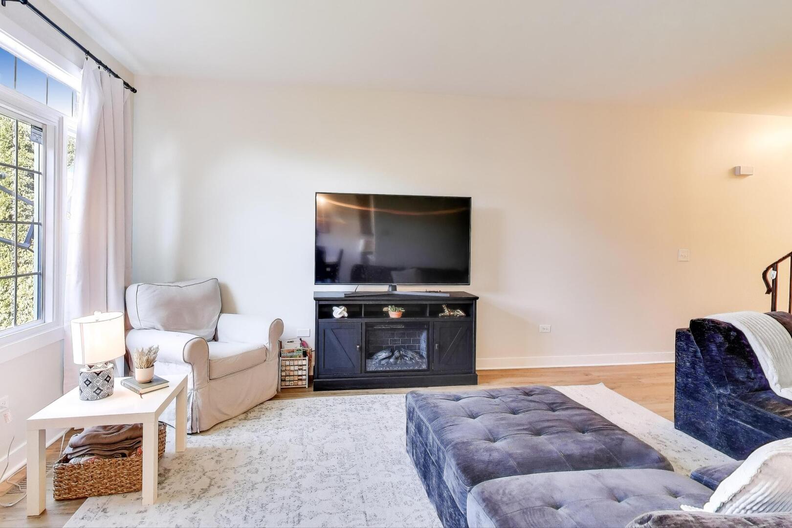 10521 Thornham Lane, Unit 10521 Mokena, IL 60448 - Photo 5 of 21 a living room with furniture and a flat screen tv