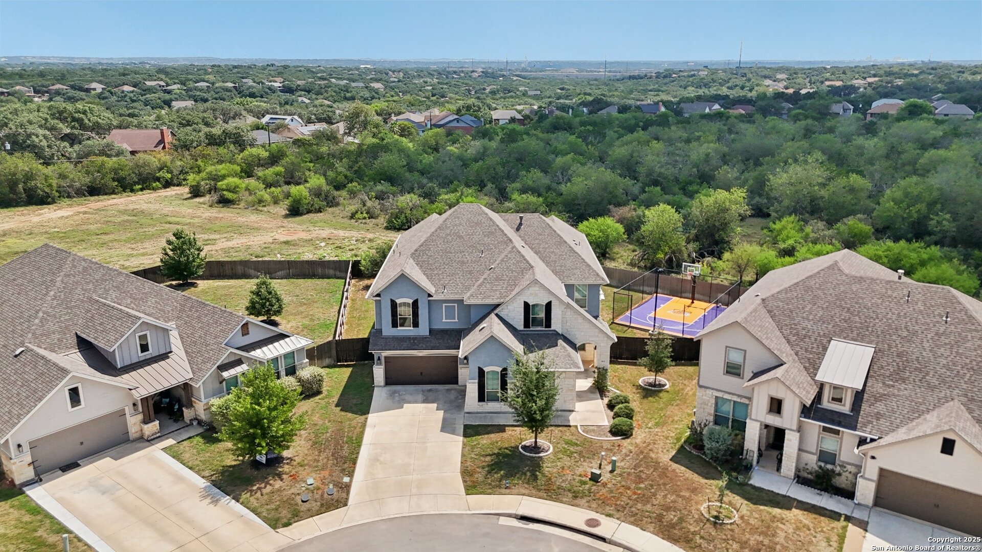 an aerial view of a house with a yard