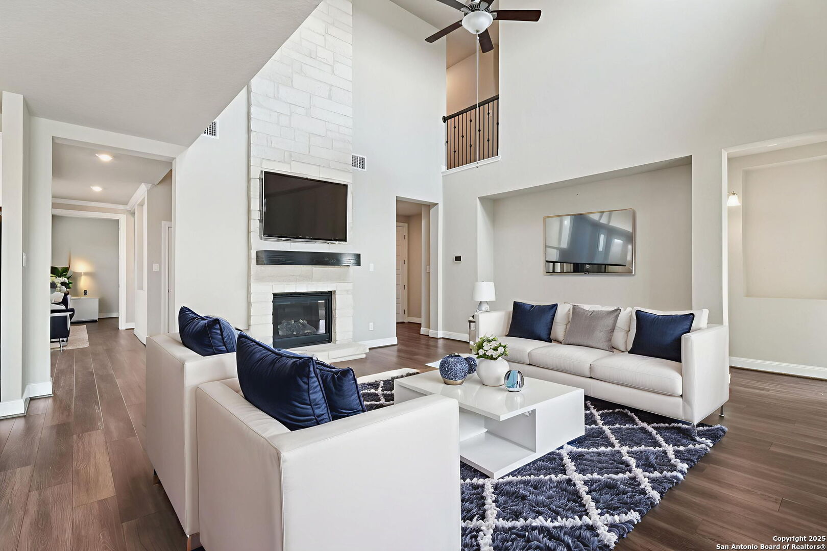 2622 Raven Ridge Point San Antonio, TX 78259 - Photo 13 of 53 a living room with furniture a flat screen tv and a fireplace