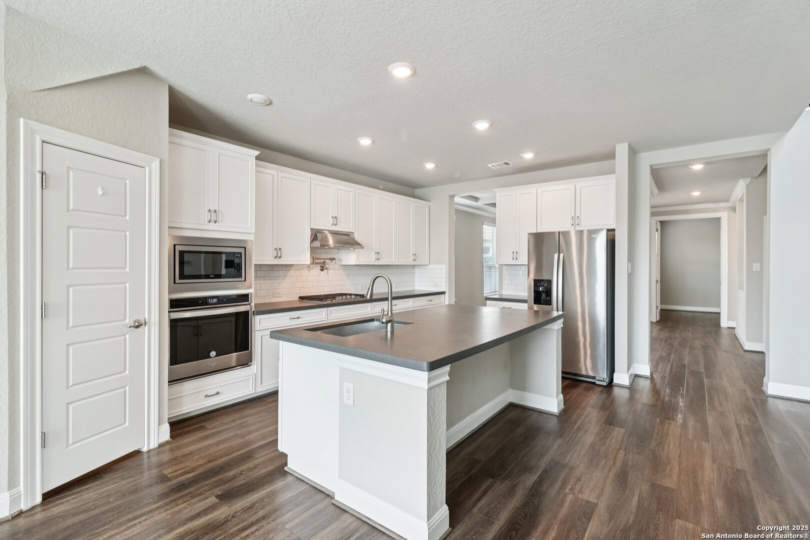 2622 Raven Ridge Point San Antonio, TX 78259 - Photo 19 of 53 a kitchen with stainless steel appliances granite countertop a refrigerator and a stove top oven