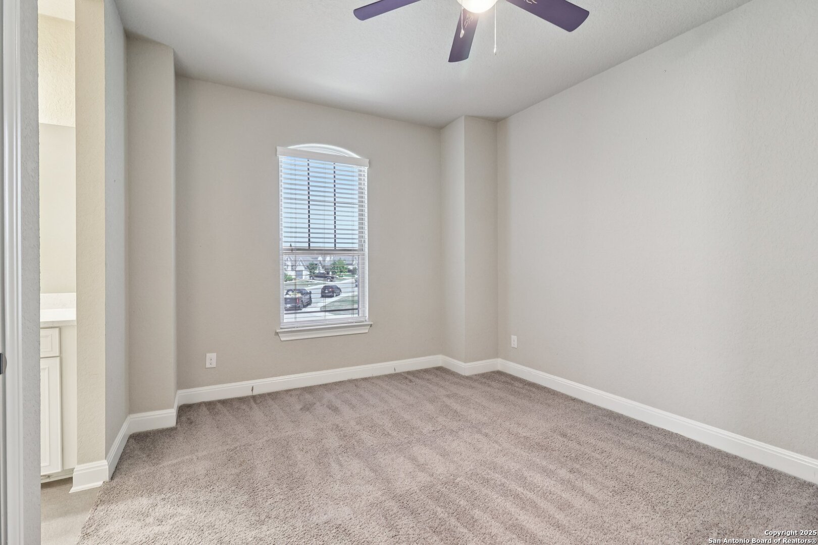 2622 Raven Ridge Point San Antonio, TX 78259 - Photo 38 of 53 an empty room with chandelier fan and windows