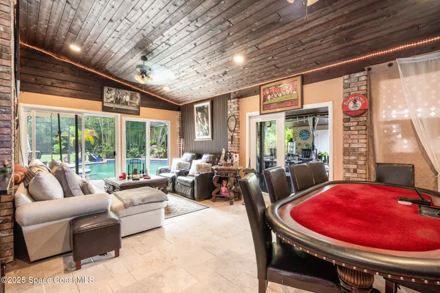 a living room with furniture a rug and a chandelier