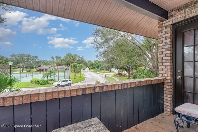 a view of a backyard with a garden and outdoor seating