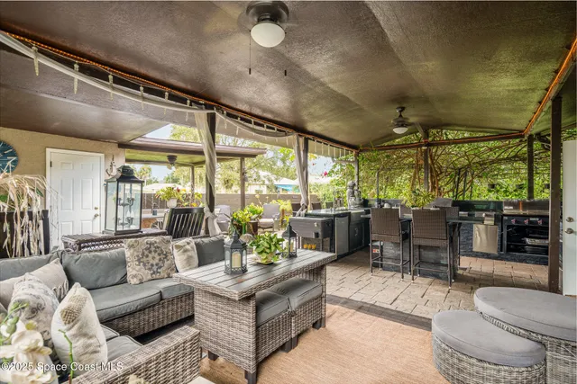 a view of an outdoor dining space with a table and chairs