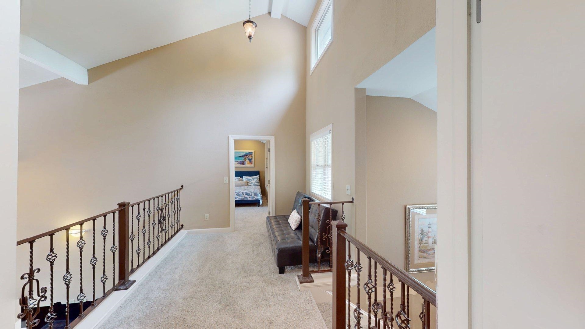 1085 Caney Hollow Road Counce, TN 38326 - Photo 26 of 39 Hall featuring an upstairs landing, healthy amount of natural light, beamed ceiling, light colored carpet, and high vaulted ceiling