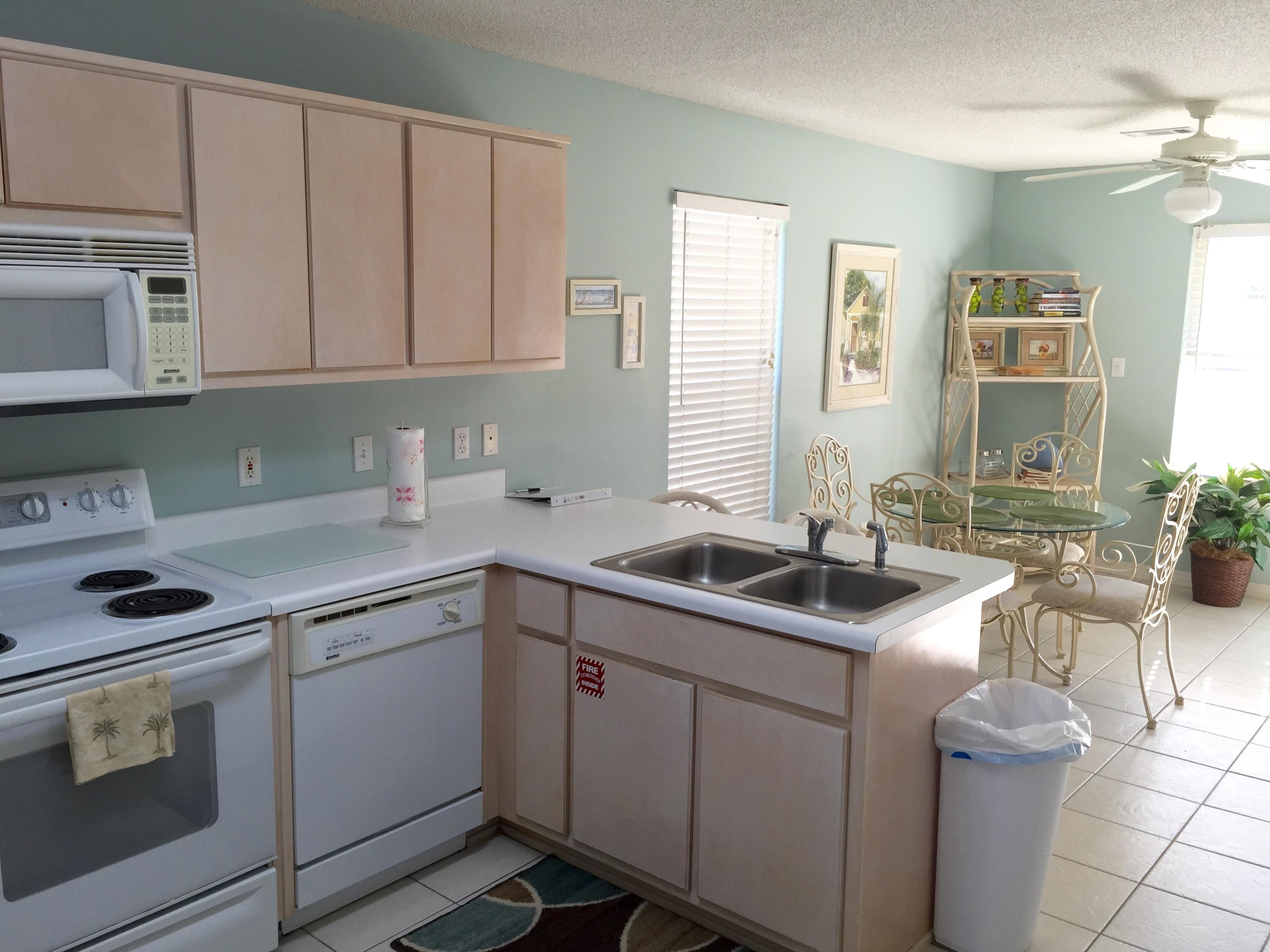 82 Sugar Sand Lane, Unit C1 Santa Rosa Beach, FL 32459 - Photo 4 of 13 a kitchen with cabinets stainless steel appliances a sink and a window