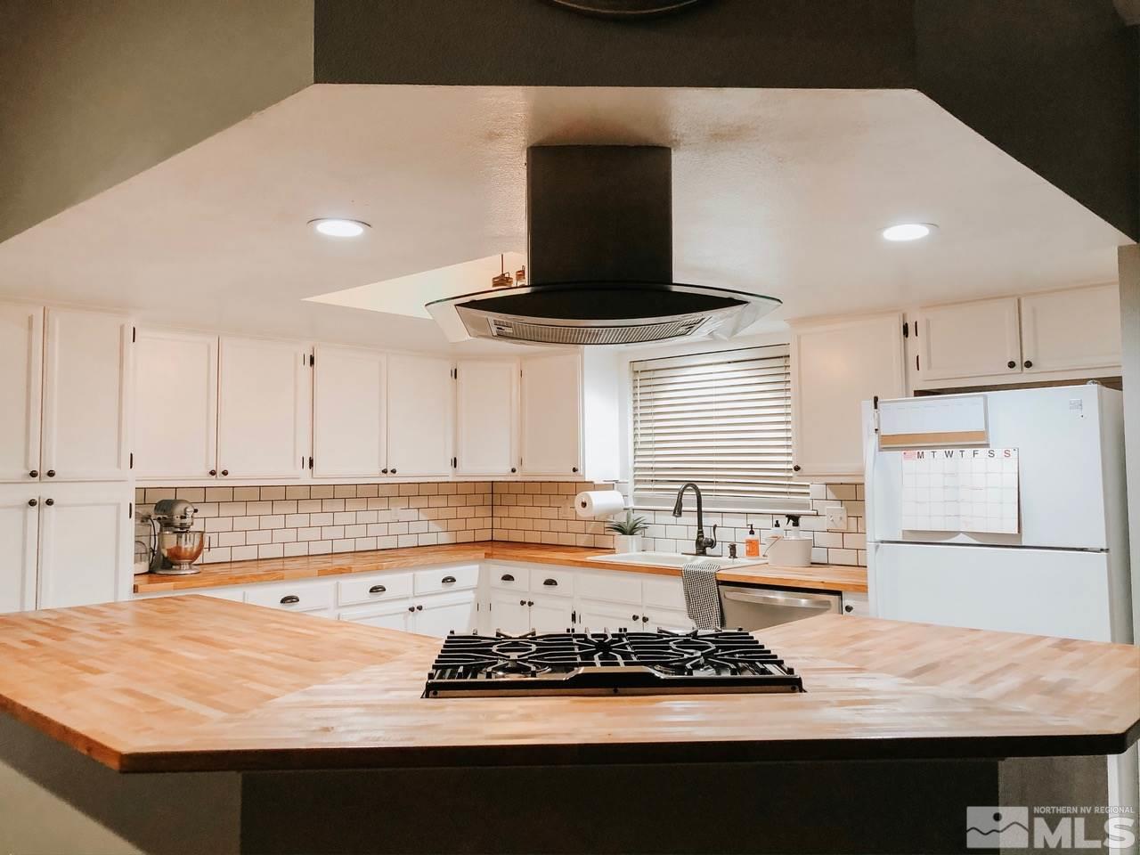 357 Lewis Lane Fallon, NV 89406 - Photo 17 of 22 a kitchen with stainless steel appliances a stove a sink and a refrigerator