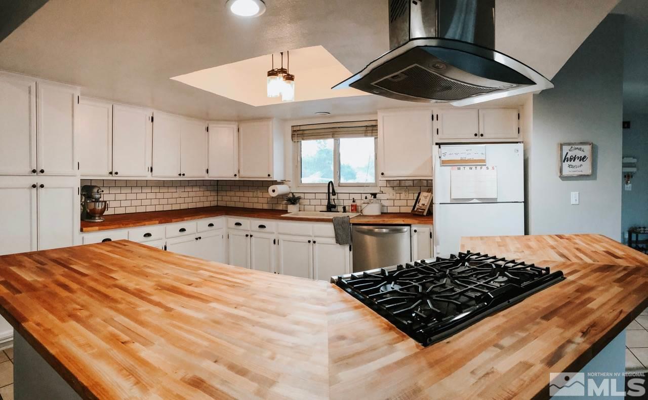 357 Lewis Lane Fallon, NV 89406 - Photo 18 of 22 a kitchen with stainless steel appliances granite countertop a sink stove and refrigerator