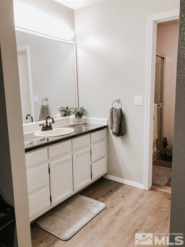 357 Lewis Lane Fallon, NV 89406 - Photo 2 of 22 a bathroom with a sink and mirror
