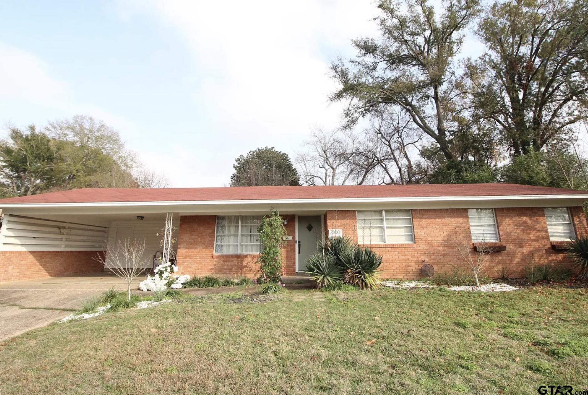2100 Pine Crest Drive Tyler, TX 75701 - Photo 1 of 12 a front view of a house with garden