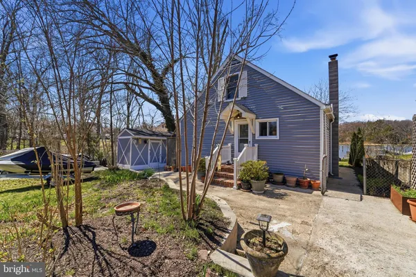 a backyard of a house with barbeque oven table and chairs