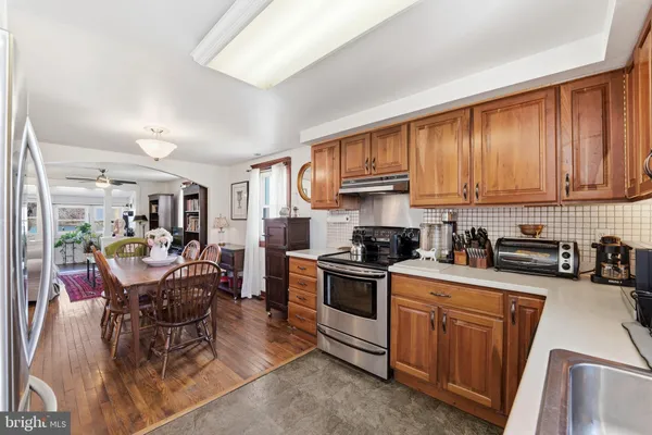 a kitchen with sink a stove and cabinets