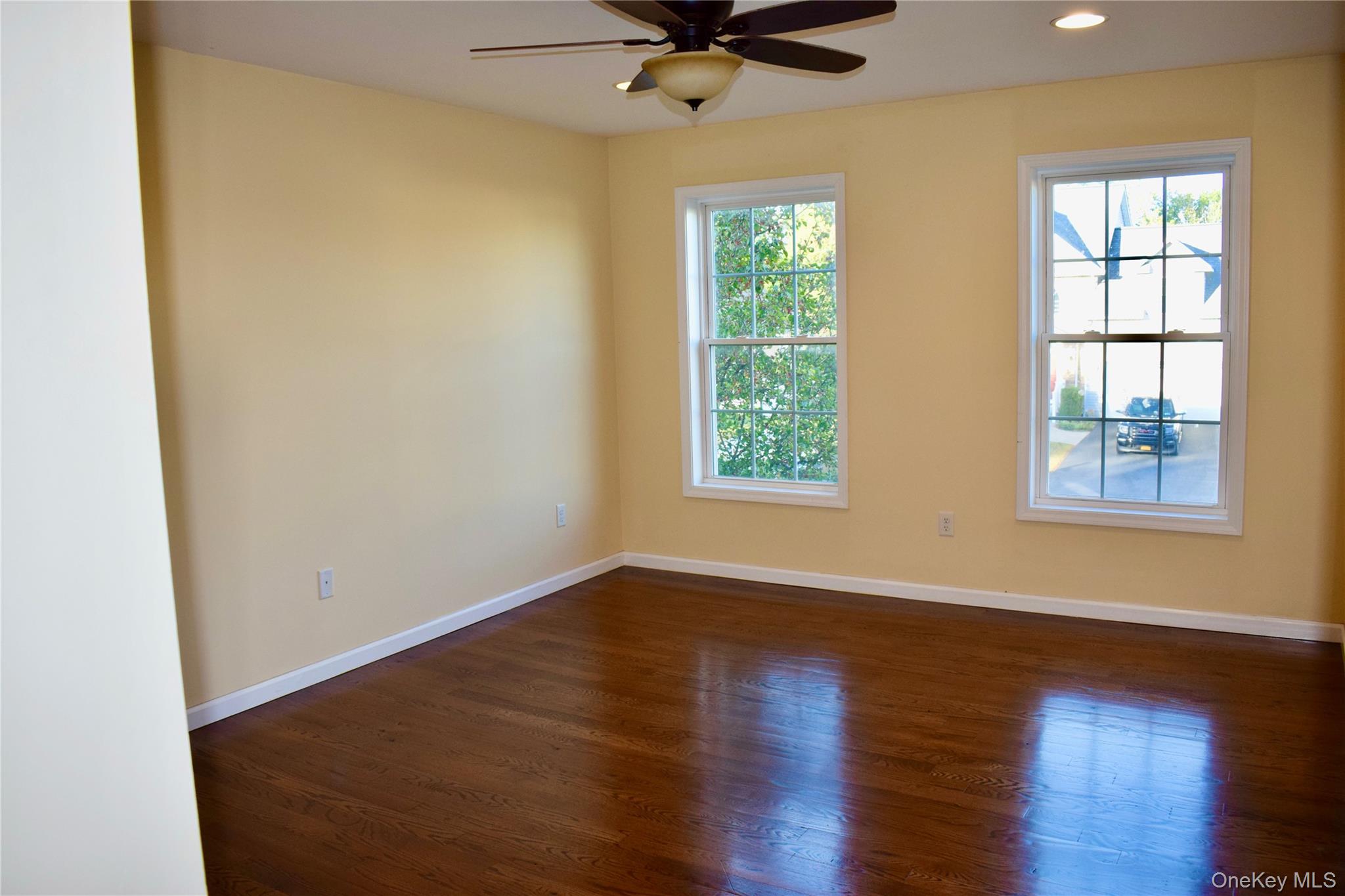 9 Alia Court Poughkeepsie, NY 12603 - Photo 17 of 37 an empty room with wooden floor fan and windows