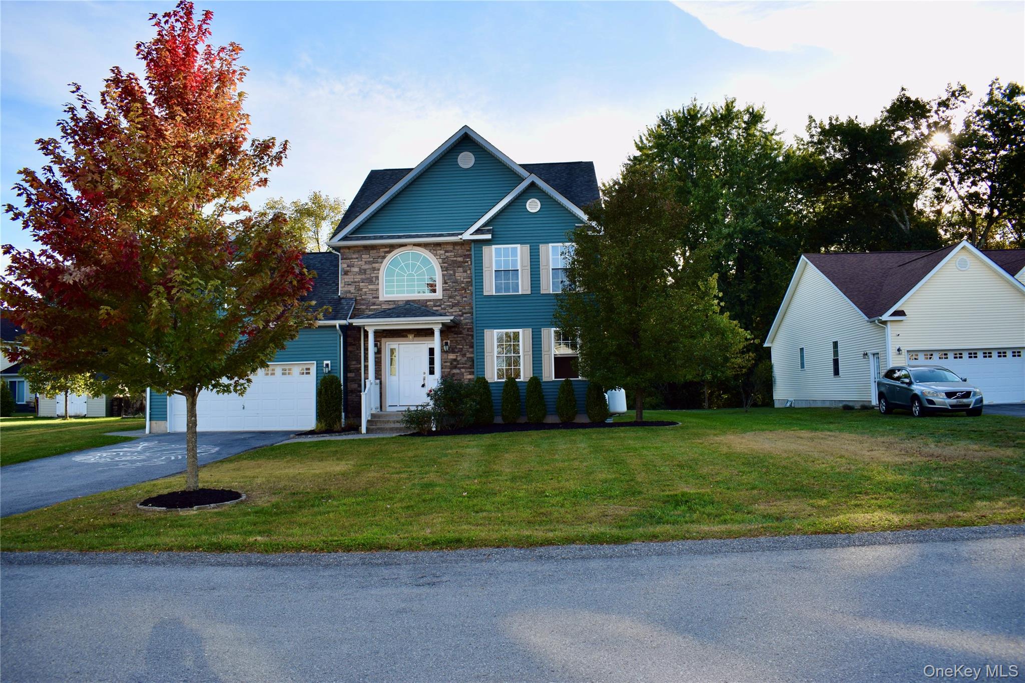 9 Alia Court Poughkeepsie, NY 12603 - Photo 2 of 37 a front view of a house with a yard and garage