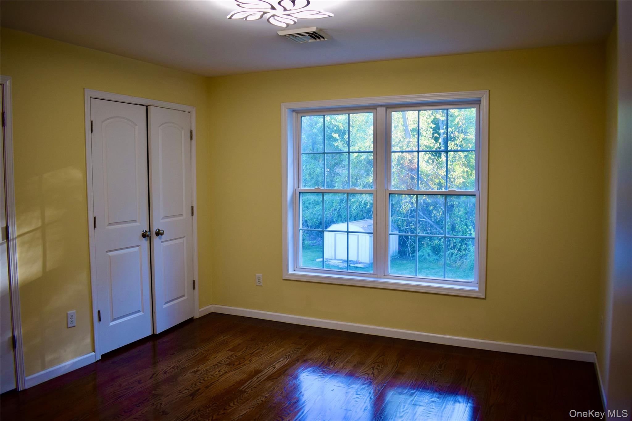9 Alia Court Poughkeepsie, NY 12603 - Photo 22 of 37 a view of an empty room with wooden floor and a window