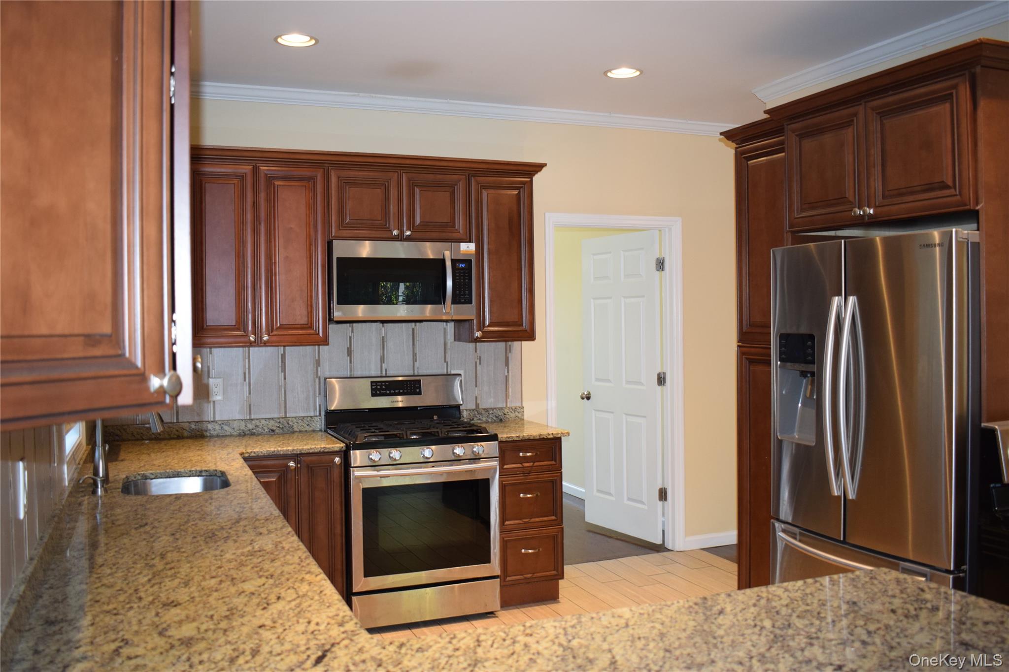 9 Alia Court Poughkeepsie, NY 12603 - Photo 7 of 37 a kitchen with stainless steel appliances granite countertop a stove a refrigerator and a microwave