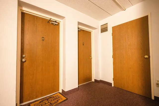 a living room with furniture a flat screen tv and a floor to ceiling window