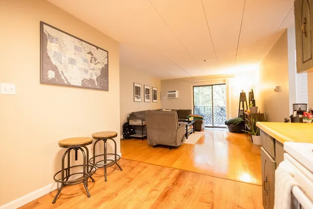 a living room with furniture and a floor to ceiling window