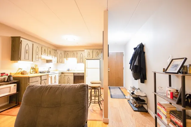 a kitchen with white cabinets sink and white appliances