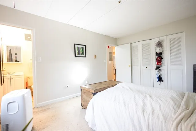 a bedroom with a bed and a large mirror