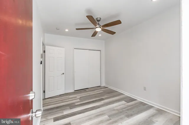 a view of a livingroom with a ceiling fan and window