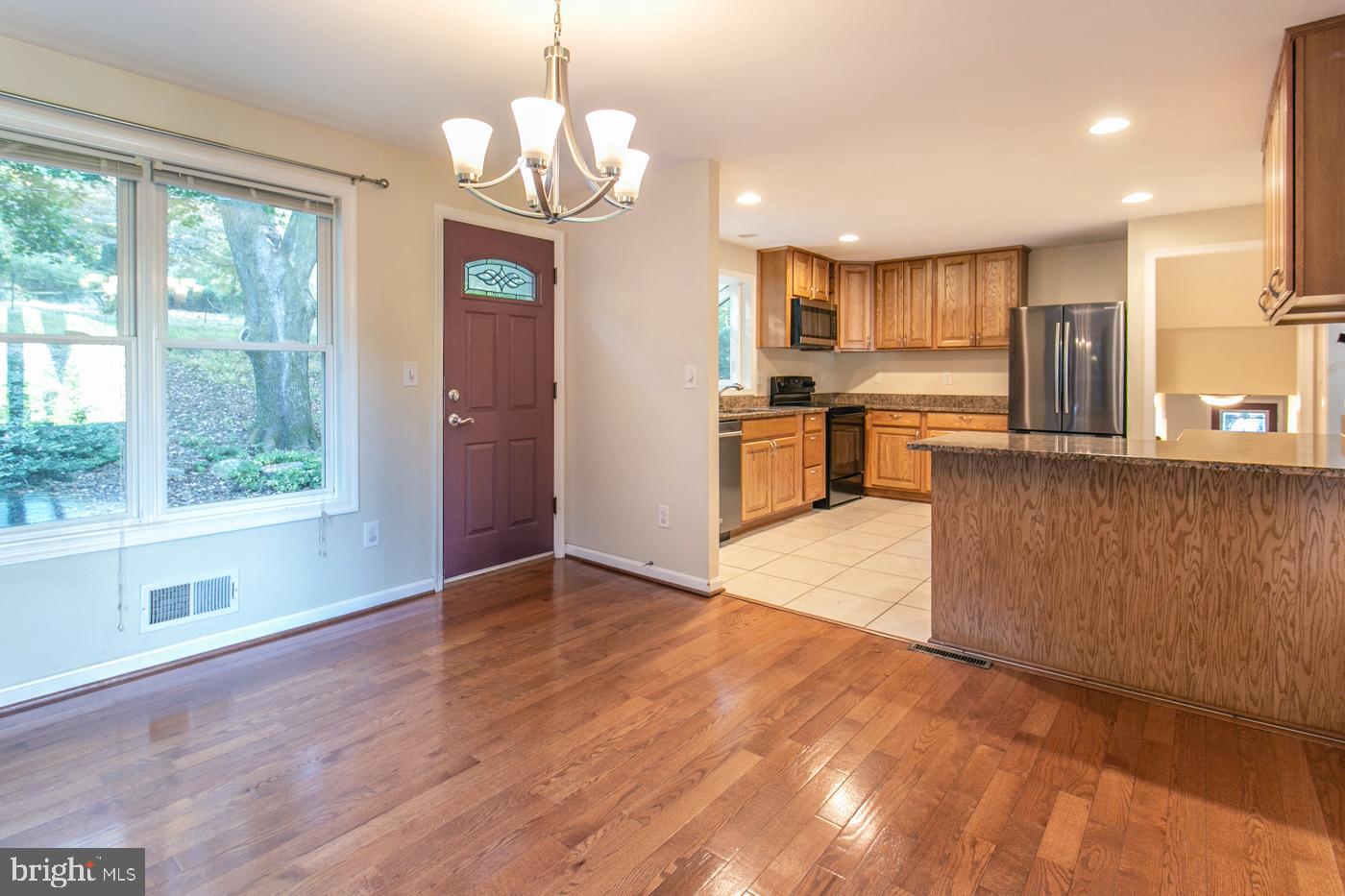 288 Devonshire Road Devon, PA 19333 - Photo 11 of 48 a view of a kitchen with stainless steel appliances granite countertop a refrigerator a stove a sink dishwasher with wooden floor and cabinets