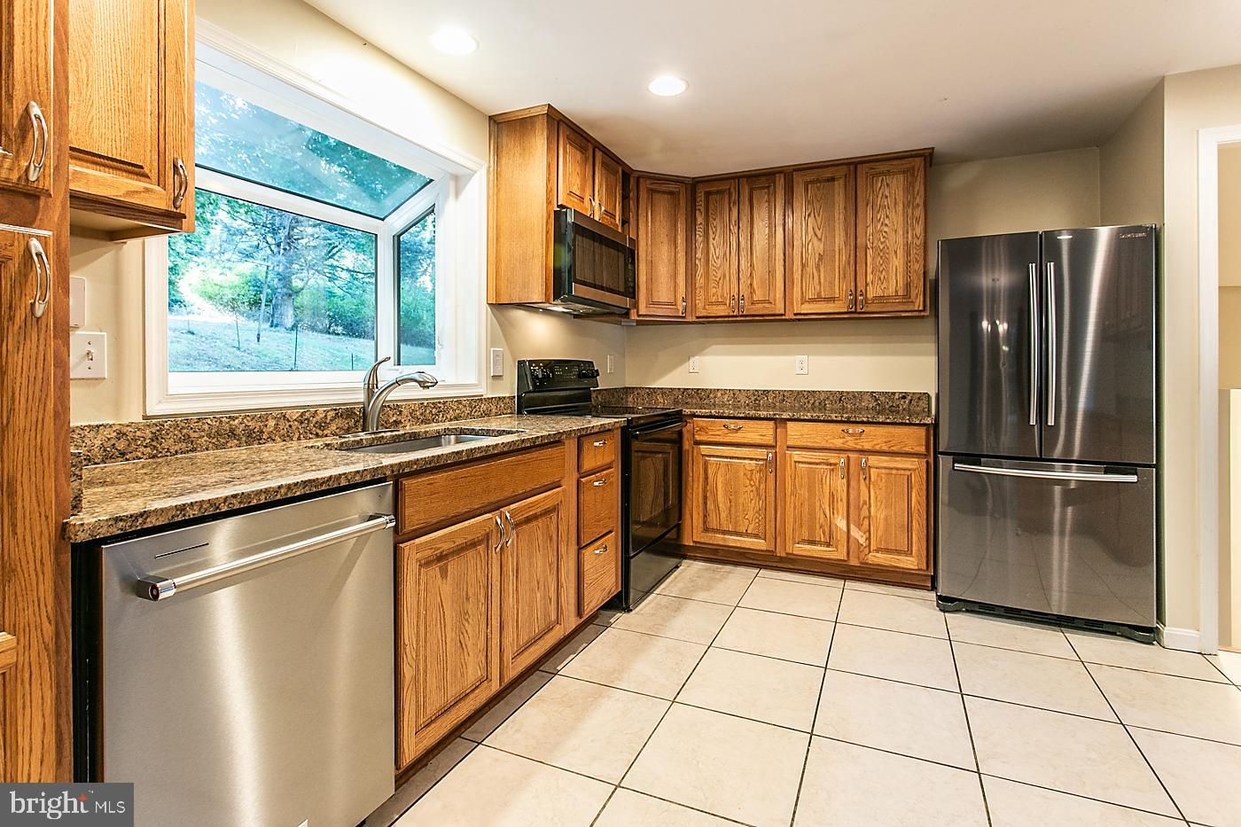 288 Devonshire Road Devon, PA 19333 - Photo 13 of 48 a kitchen with stainless steel appliances granite countertop a refrigerator sink and cabinets