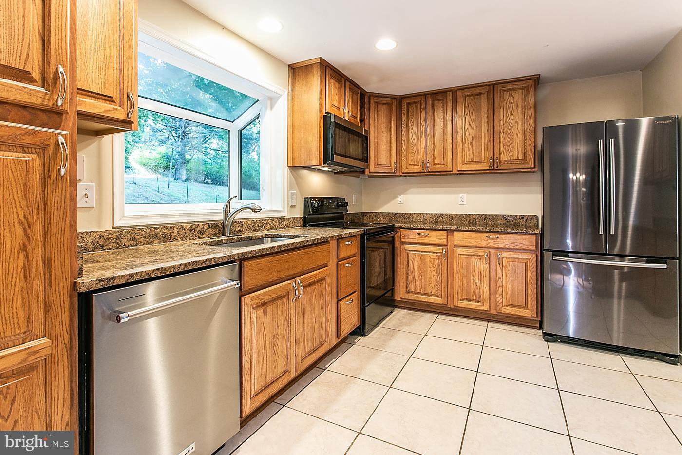 288 Devonshire Road Devon, PA 19333 - Photo 14 of 48 a kitchen with stainless steel appliances granite countertop a refrigerator sink and cabinets