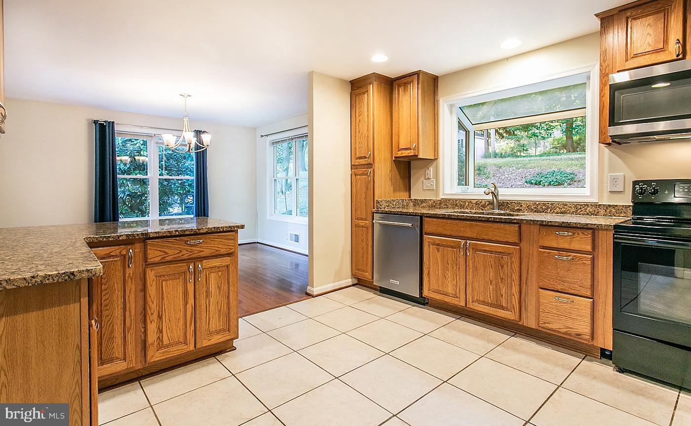 288 Devonshire Road Devon, PA 19333 - Photo 18 of 48 a kitchen with stainless steel appliances granite countertop a stove a sink and a refrigerator