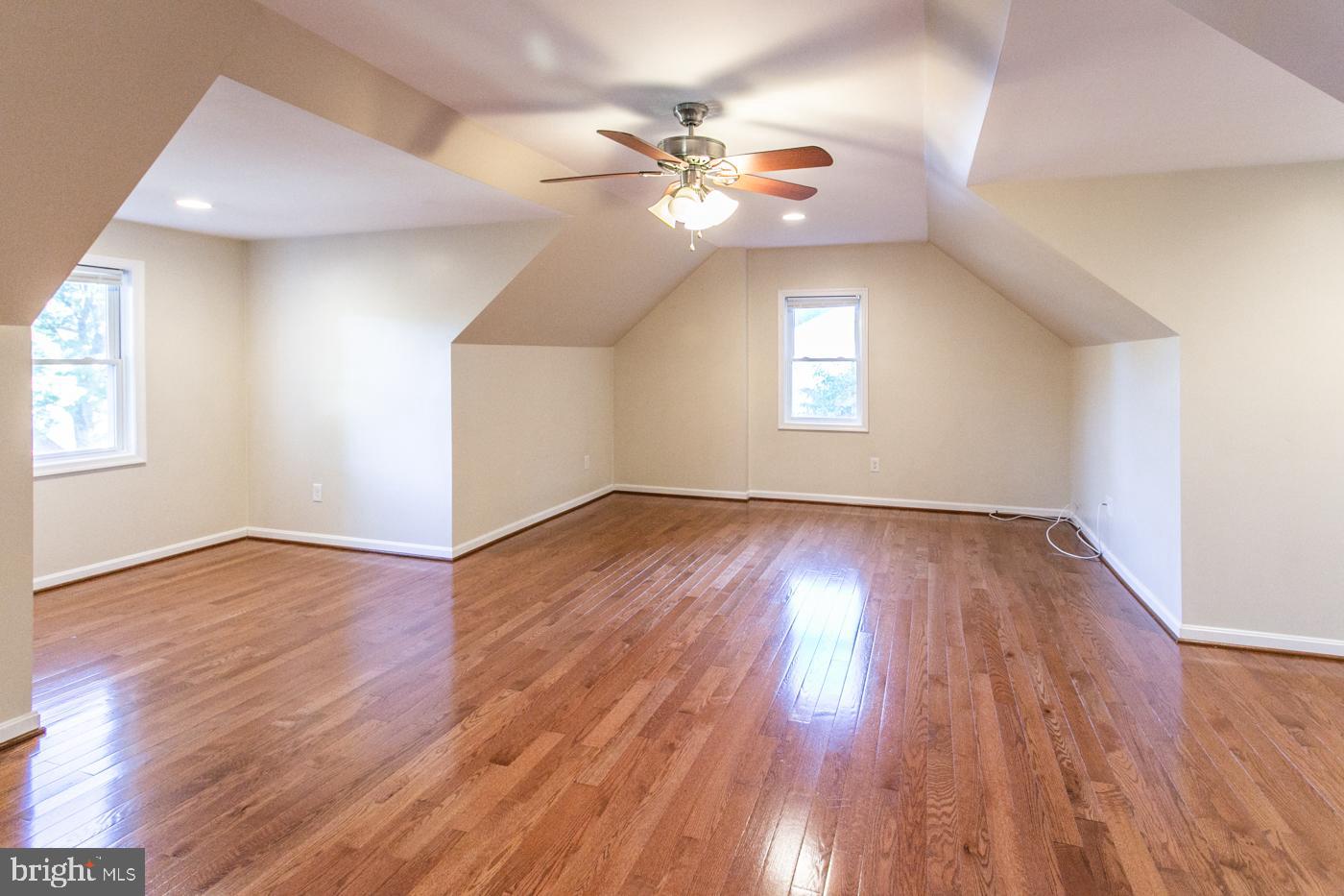 288 Devonshire Road Devon, PA 19333 - Photo 30 of 48 an empty room with wooden floor chandelier fan and windows
