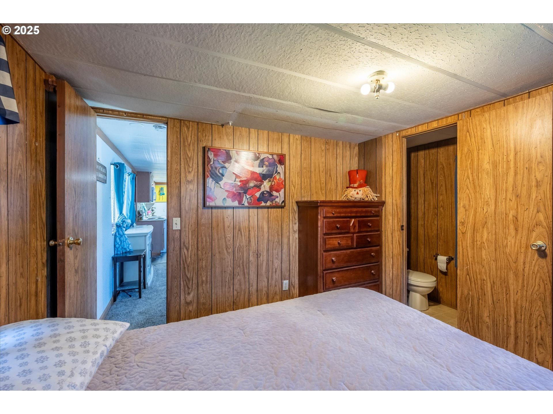 125 North 4th Street Lakeside, OR 97449 - Photo 24 of 38 a bedroom with a bed and a flat screen tv