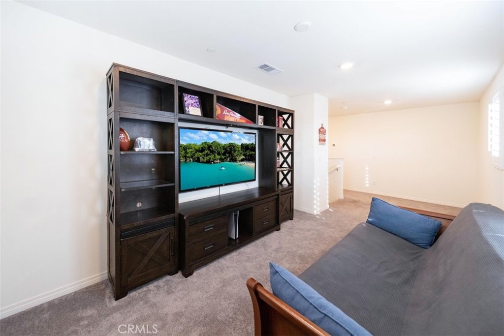 32078 Rambling Court Winchester, CA 92596 - Photo 26 of 48 a living room with furniture and a flat screen tv