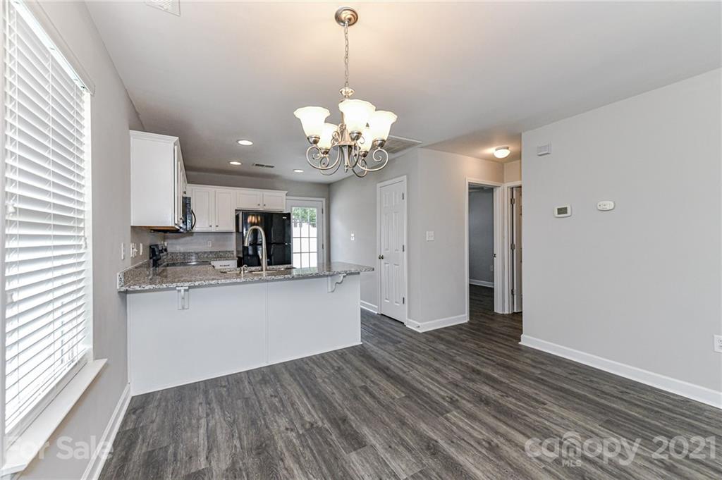 1894 Sandal Brook Road Indian Land, SC 29707 - Photo 11 of 30 a kitchen with stainless steel appliances granite countertop a sink cabinets a refrigerator and a stove