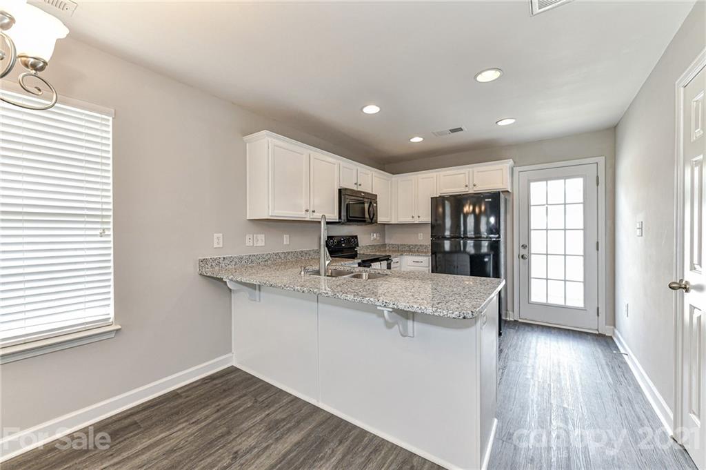 1894 Sandal Brook Road Indian Land, SC 29707 - Photo 12 of 30 a large kitchen with granite countertop a large counter top stainless steel appliances and cabinets