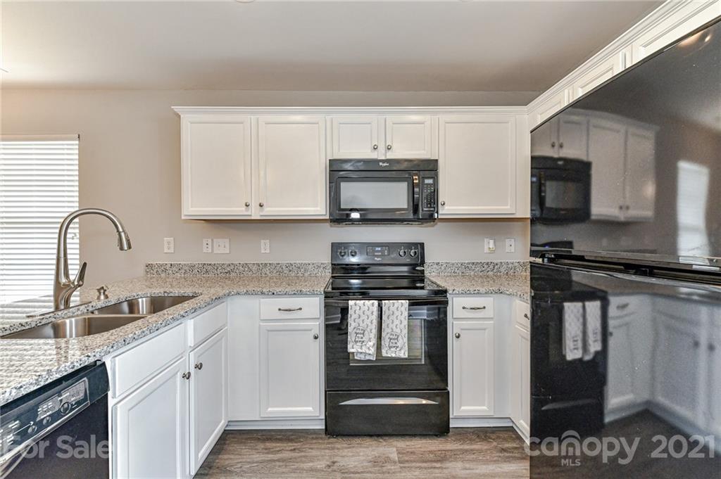 1894 Sandal Brook Road Indian Land, SC 29707 - Photo 14 of 30 a kitchen with stainless steel appliances granite countertop a stove a sink and a microwave