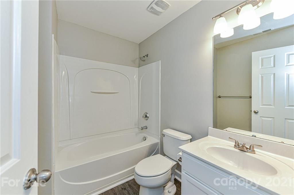 1894 Sandal Brook Road Indian Land, SC 29707 - Photo 24 of 30 a bathroom with a granite countertop toilet a sink and a bathtub