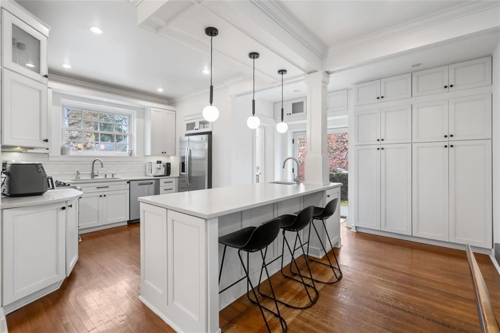 6649 Kinsman Road Pittsburgh, PA 15217 - Photo 8 of 37 Lots of storage, a large center island with seating and modern lighting makes this kitchen ultra appealing!