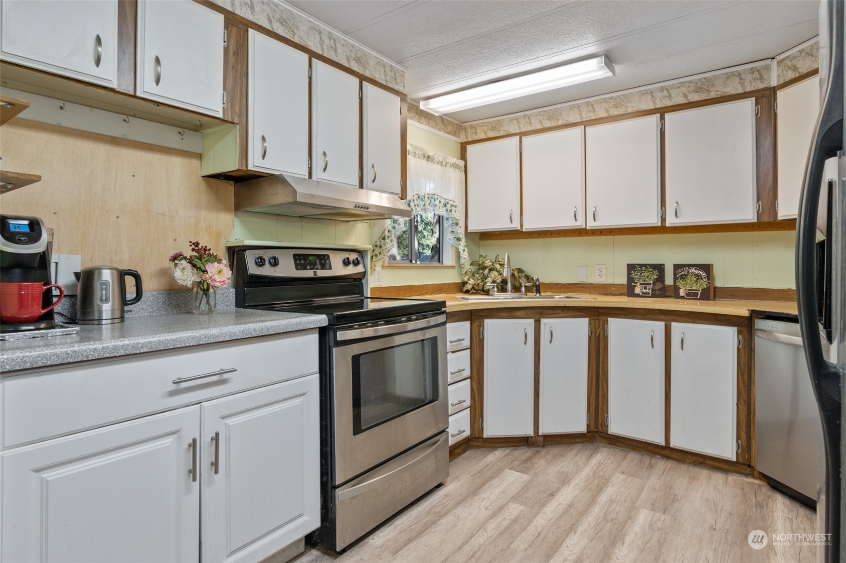 8117 176th Avenue Southwest Rochester, WA 98579 - Photo 12 of 27 a kitchen with granite countertop a sink cabinets stainless steel appliances and a window