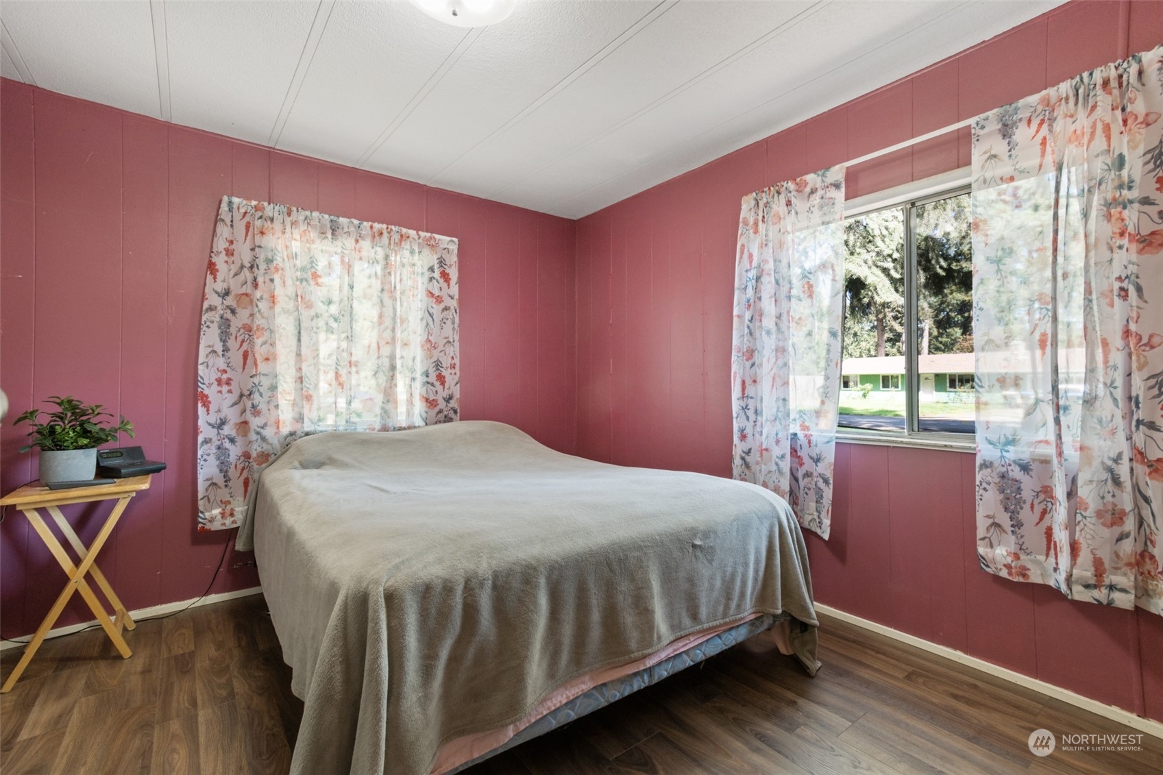 8117 176th Avenue Southwest Rochester, WA 98579 - Photo 21 of 27 a bedroom with a bed and wooden floor