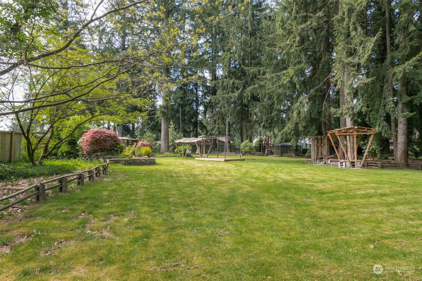8117 176th Avenue Southwest Rochester, WA 98579 - Photo 23 of 27 a backyard of a house with table and chairs